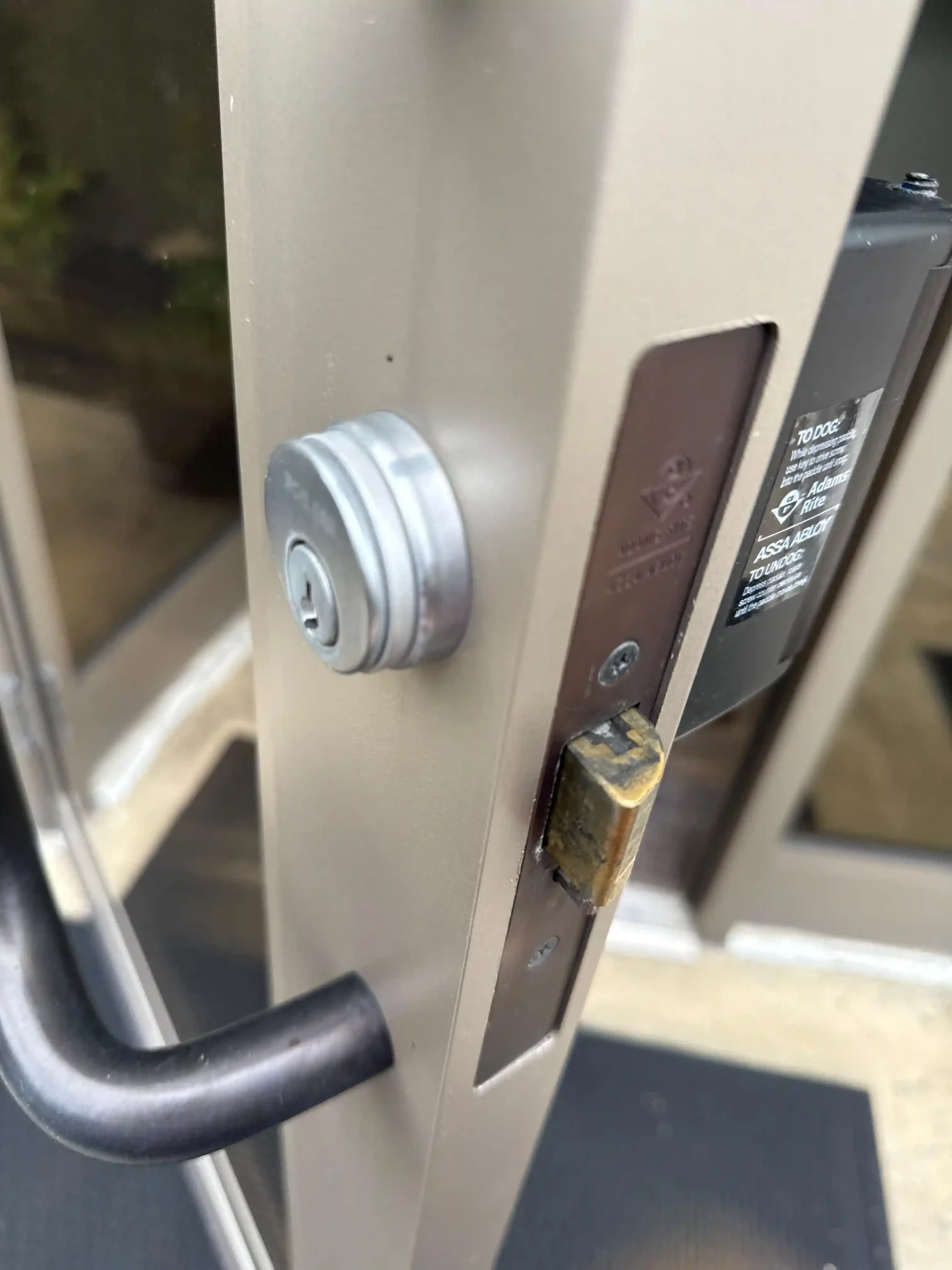 Commercial lock repair service by AA Locksmith Near Me LLC, featuring a close-up of a storefront door's mortise lock.