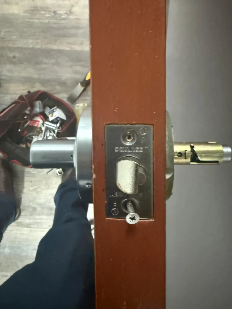 Close-up of a door showing a Schlage deadbolt being installed, demonstrating AA Locksmith Near Me LLC's deadbolt installation service.
