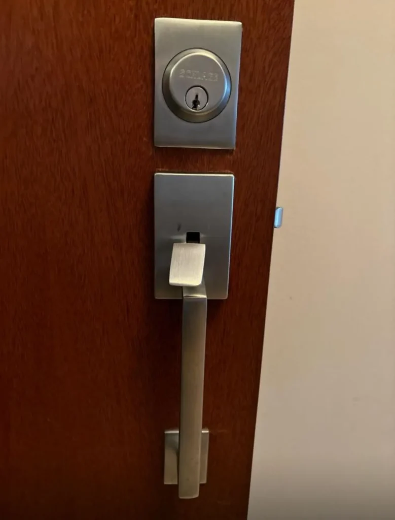 Standard door lock and handle with a deadbolt lock, representing quality locksmith services for home security