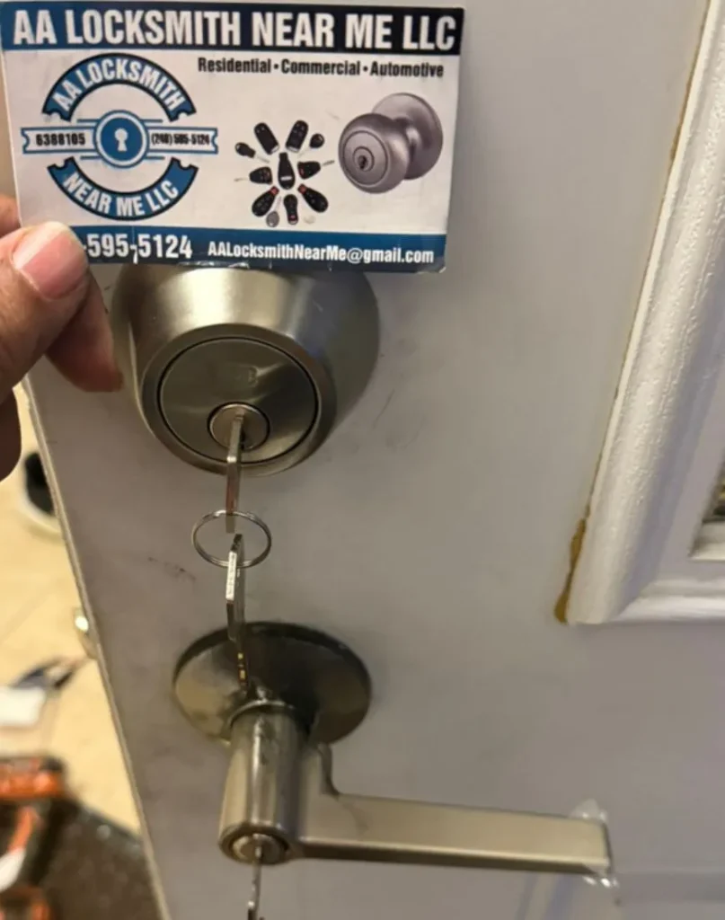 Lock with key and business card from AA Locksmith Near Me LLC, showcasing residential locksmith services